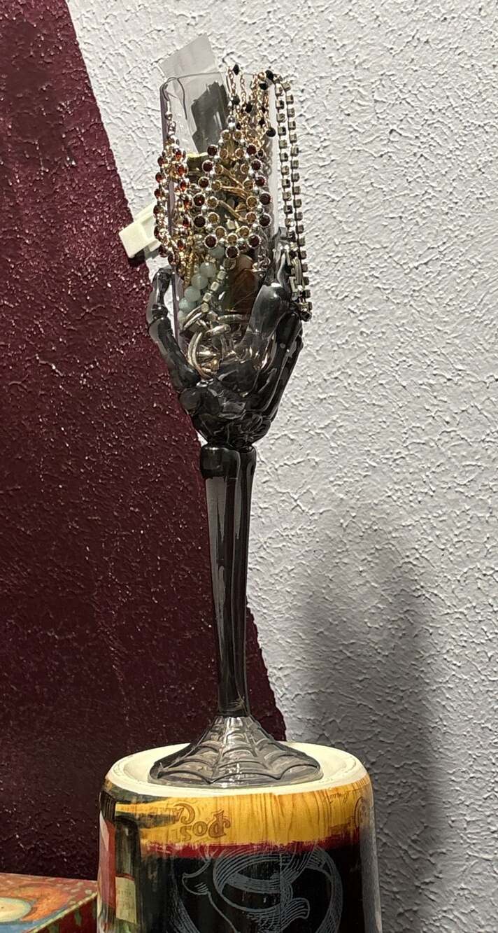 Trick or treat yourself to a skeleton hand on a flute full of jewelry
